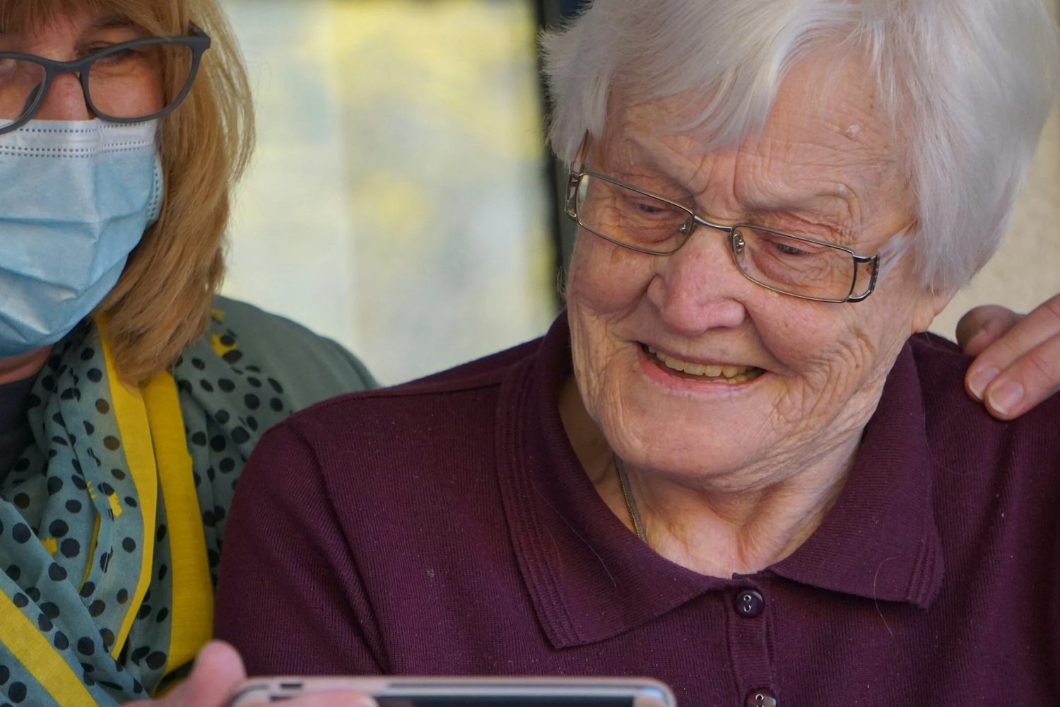 A caring advisor supporting a senior at home