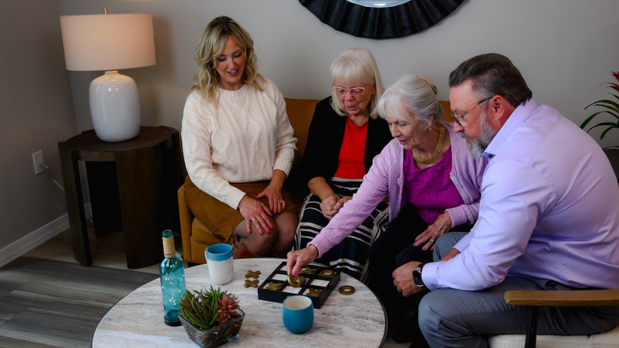 Residents and advisors playing a game together in an independent living community