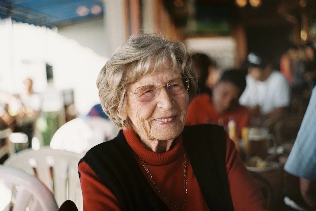 A smiling senior woman receiving attentive memory care